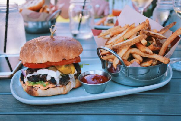 A burger with fries at an outdoor restaurant