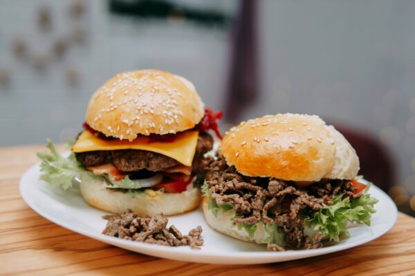 Burgers with beef and vegetables. Delicious burgers in a cooking class. Burger with cranberry sauce