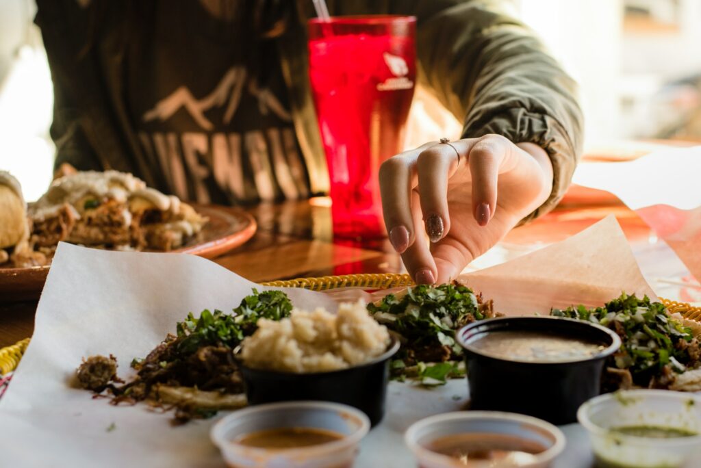 Girl at a restaurant picking up Mexican food