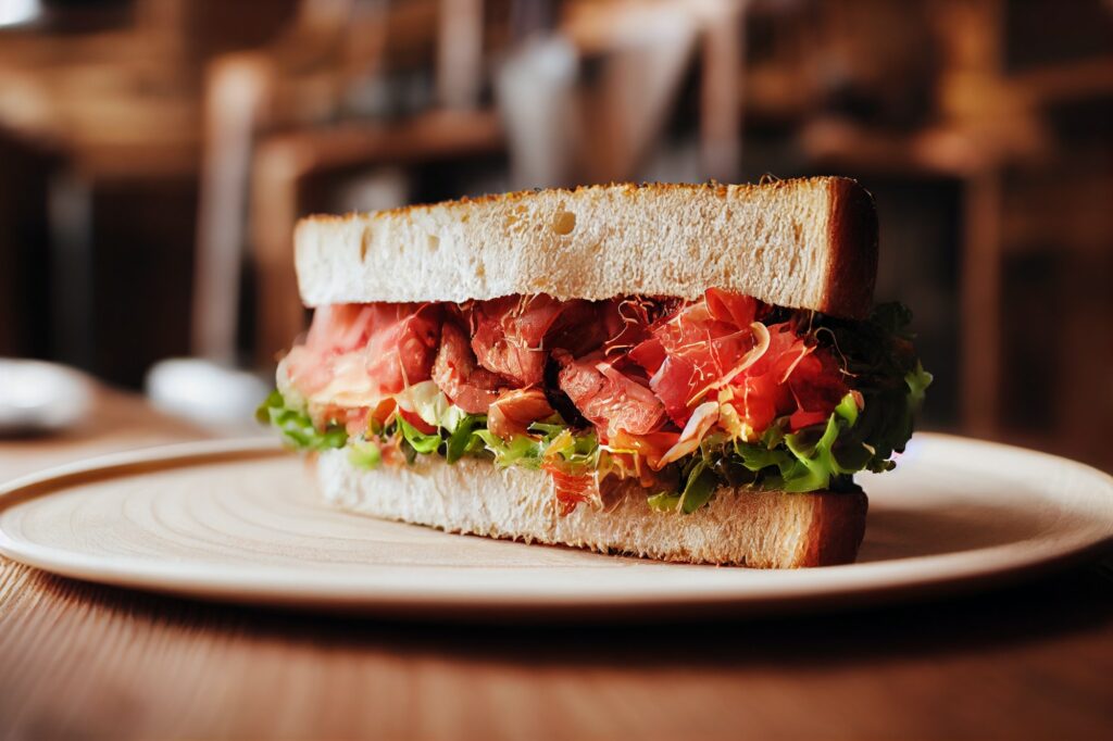 healthy sandwich on a wooden table, eating fast food with greens concept, food and drink restaurant